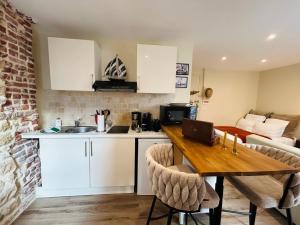 a kitchen with a table with a laptop on it at Séjour à Trouville Le Studio in Trouville-sur-Mer