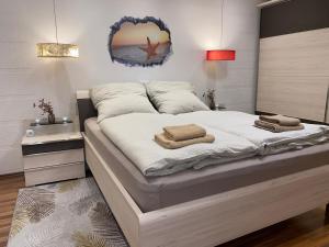 a bedroom with a large bed with towels on it at FeWo Wagner in Fuggerstraße in Dillingen an der Donau