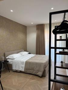a bedroom with a bed and a book shelf at 50 Passi dal Duomo in Marcianise