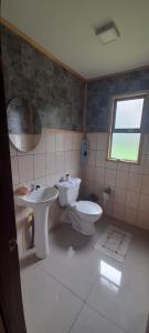 ein Badezimmer mit Toilette und Waschbecken in der Unterkunft Casa en la playa in Valdivia + 14 Fotos