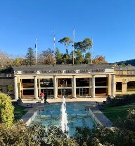 a person standing in front of a building with a fountain at Le Paradis' c'est ici in Gréoux-les-Bains