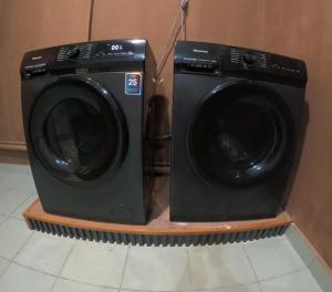 a washing machine is sitting next to a wall at Megah Inn Home Inanam in Kota Kinabalu +44 photos