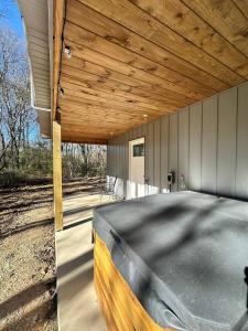 een overdekte veranda met een houten dak aan een huis bij Willow Oak Cottage in Fort Payne