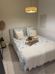 a bedroom with a bed with a table on it at Studio t2 in Mornas