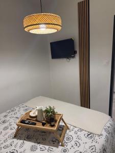 a bed with a tray with a table on it at Studio t2 in Mornas