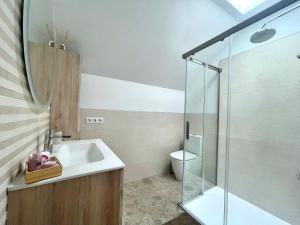 a bathroom with a sink and a glass shower at Penthouse Jul&Mel in Valle Gran Rey