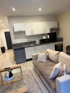 a living room with a couch and a kitchen at Studio t2 in Mornas