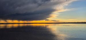 un ciel nuageux au-dessus d'un plan d'eau dans l'établissement Luxury Lodge Costa Blanca, à San Antonio Oeste 2 autres photos