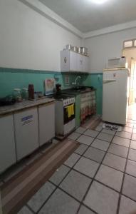a kitchen with a stove and a refrigerator at Casa quarto dormitório estudantil a 100m da UESC em salobrinho para uescquianos in Ilhéus +20 photos
