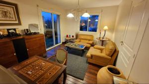 a living room with a couch and a table at Magnifique T3 RDC vue mer-accès plage direct chez CATH in Trébeurden