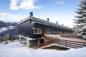 a house on the side of a mountain in the snow at Lo Gnomo Apartment in Marilleva
