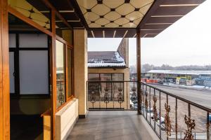 a balcony with a view of a parking lot at РИМ Garden in Almaty