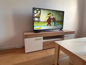 a flat screen tv sitting on top of a wooden entertainment center at Bjelašnica by Samke in Bjelašnica