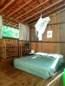 een slaapkamer met een bed in een houten kamer bij Casa Ganesha in Itacaré