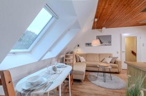 a living room with a couch and a table at Der Ferienhof am Meer in Fehmarn