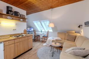a living room with a couch and a table at Der Ferienhof am Meer in Fehmarn