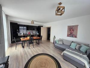 a living room with a couch and a table at Provence Ap 308 Băile Felix in Baile Felix +11 photos