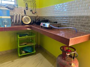 a kitchen with a counter top and a shelf at KARDOM Homes Moran in Morānha