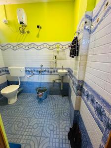 a bathroom with a toilet and a sink at KARDOM Homes Moran in Morānha +70 photos