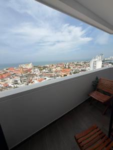 a balcony with a bench and a view of a city at Del Mar City View in Cartagena de Indias