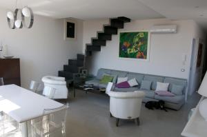 a living room with a couch and a staircase at Casa Maria in Salerno