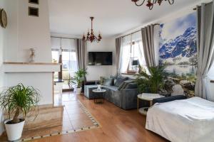 a living room with a couch and a fireplace at Willa Dukat in Czarny Dunajec
