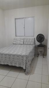 En eller flere senge i et værelse på Casa Novo Jardim