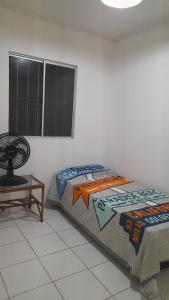 En eller flere senge i et værelse på Casa Novo Jardim