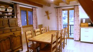 a dining room with a wooden table and chairs at Adret in Saint-Martin-de-Belleville