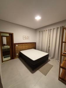 a bedroom with a bed and a sink in it at casa refugio das bromelhas in Itacaré