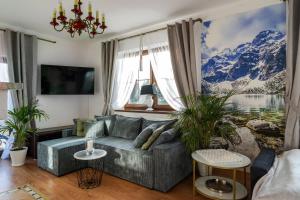 a living room with a couch and a large window at Willa Dukat in Czarny Dunajec