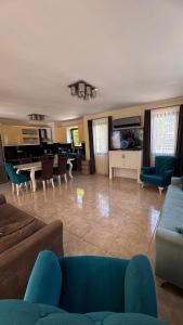 a living room with a blue couch and a piano at Dalyan Turaman private pool sleeps 10 in Ortaca