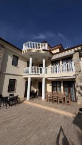 a large building with tables and chairs in front of it at Dalyan Turaman private pool sleeps 10 in Ortaca