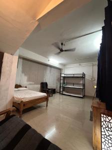 a bedroom with a bed and a ceiling at Sabari Rooms in Erumeli