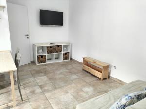 a living room with a tv on a white wall at SalMar Campomarino in Campomarino