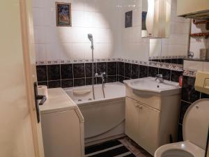a bathroom with a tub and a sink and a toilet at Apartment Bistrik mahala in Sarajevo