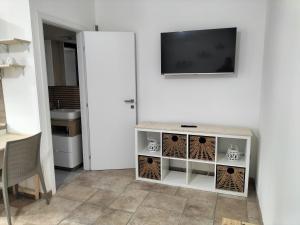 a living room with a tv and a white cabinet at SalMar Campomarino in Campomarino +9 photos