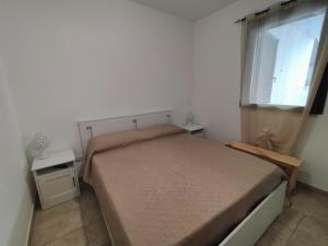 a small bedroom with a bed and a window at SalMar Campomarino in Campomarino