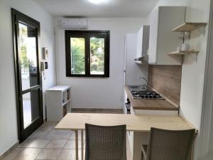 a small kitchen with a wooden table and a stove at SalMar Campomarino in Campomarino