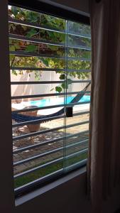 a window with a view of a train tracks at Pousada da Sol na Praia do Frances in Praia do Frances