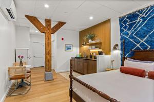 a bedroom with a bed and a cross on the wall at The Optimist Guesthouse | 2 in Camden