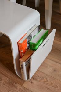 a white refrigerator with books inside of it at Triplex Léonie - Standing and Comfort - 3 étoiles in Cluses
