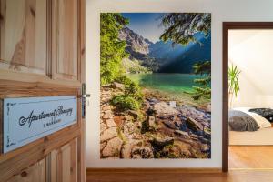 a room with a door with a mountain view wall mural at Willa Dukat in Czarny Dunajec