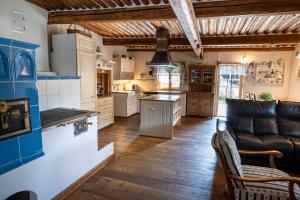 a large kitchen with a couch and a table at Jizerská roubenka in Bohdalovice