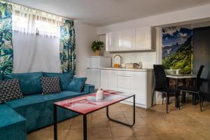 a living room with a blue couch and a table at Willa Dukat in Czarny Dunajec