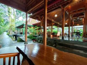 a pavilion with a wooden table and chairs at NOBE Villas in Salakan