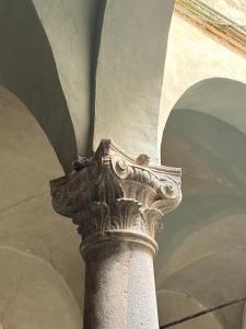a stone column in a building with a ceiling at DIMORA MedioEvo in Orvieto