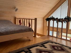 a bedroom with a bed and a large window at Forest Hills in Yaremche