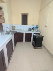 a kitchen with a sink and a stove in it at Hamza Hostel in Zanzibar City +20 photos