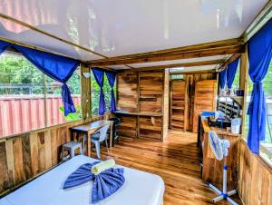 a room with a bed and a table in a house at Arbura in Uvita